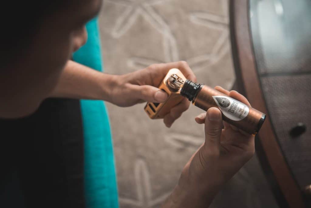 Person filling up a cannabis vape device