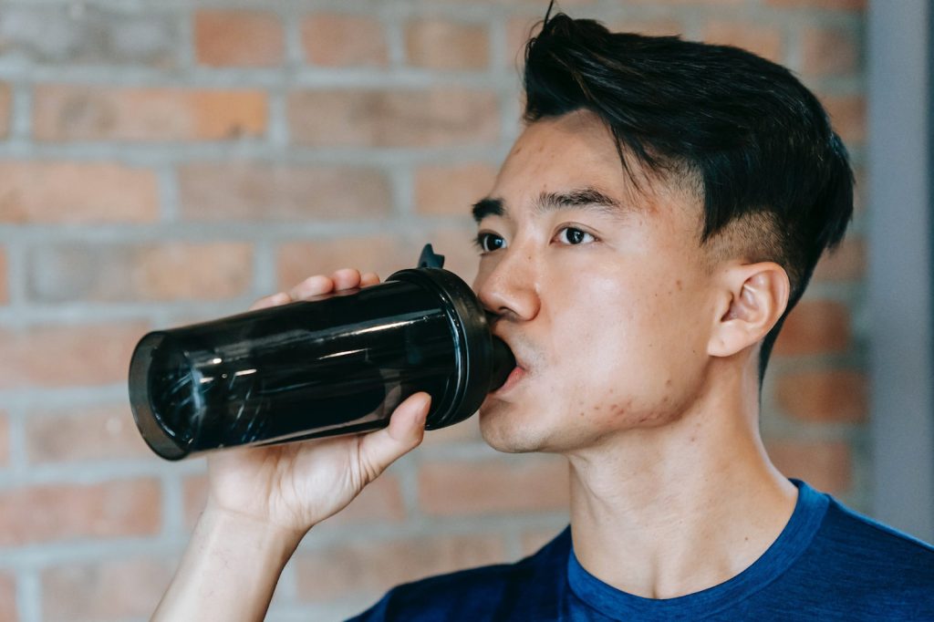 a guy drinking beverage - featured image
